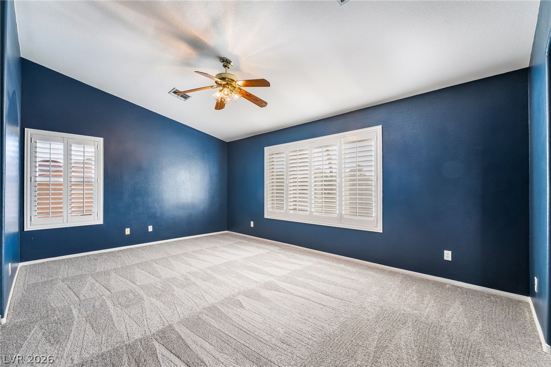 261 Timber Hollow Street Henderson, NV 89012 - Photo 29 of 51 Well-lit living area featuring rich, deep blue walls and a cooling ceiling fan.
