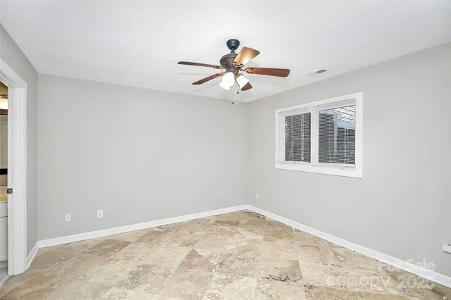 a view of a room with window and ceiling fan