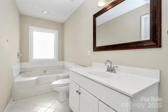 a bathroom with a toilet a sink a bathtub and a mirror