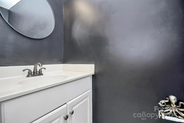 a view of a kitchen with wooden floor and a ceiling fan