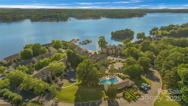 an aerial view of a houses with a lake view
