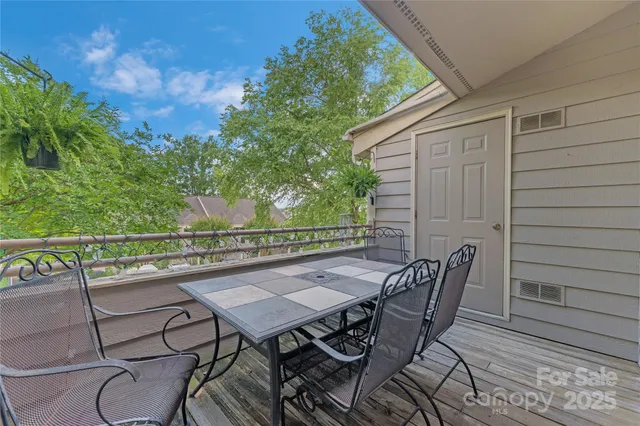 a view of balcony with furniture and potted plants