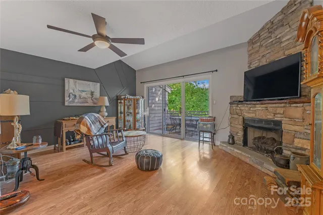 a living room with furniture a fireplace and a flat screen tv