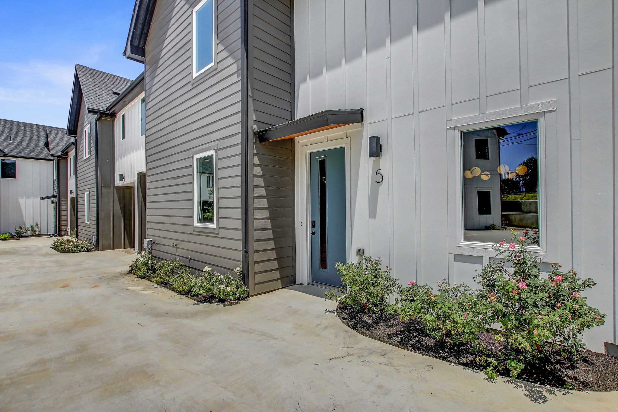 4127 East 12th Street, Unit 5 Austin, TX 78721 - Photo 28 of 33 Doorway to property with board and batten siding and a patio area