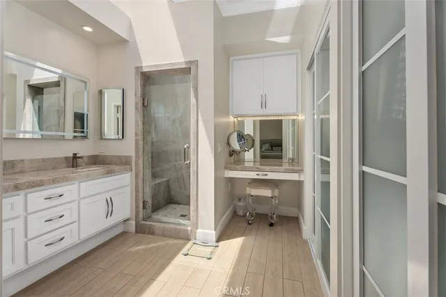 a bathroom with a granite countertop sink mirror and shower