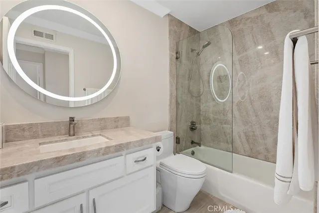 a large bedroom with a bed and a dresser