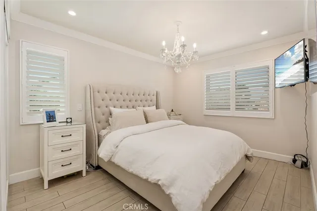 a living room with furniture a flat screen tv and a large window