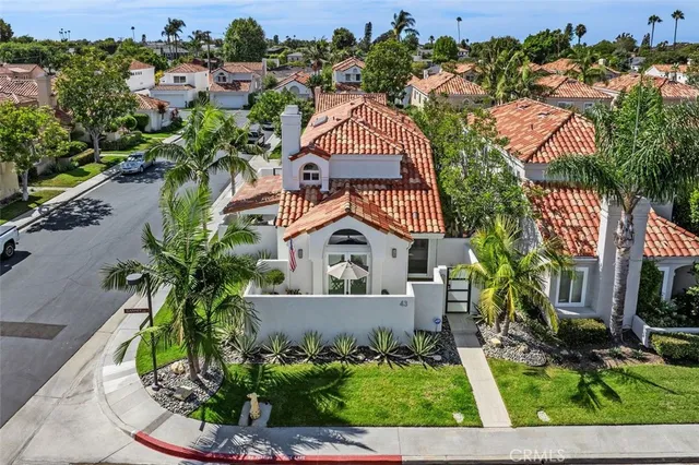 an aerial view of residential houses with outdoor space and street view