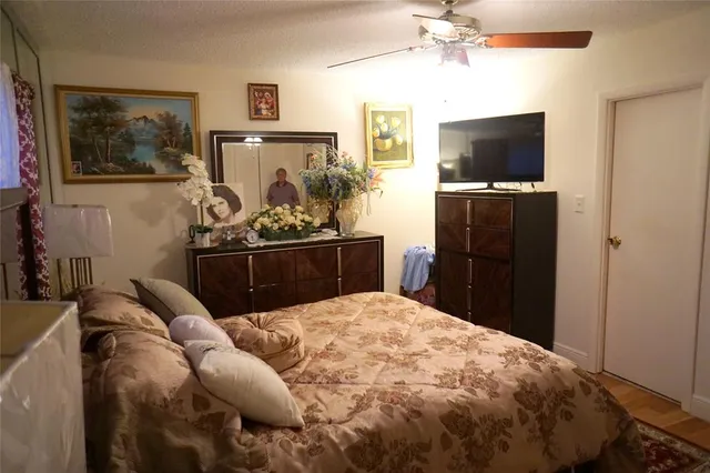 a bed room with a bed and a television