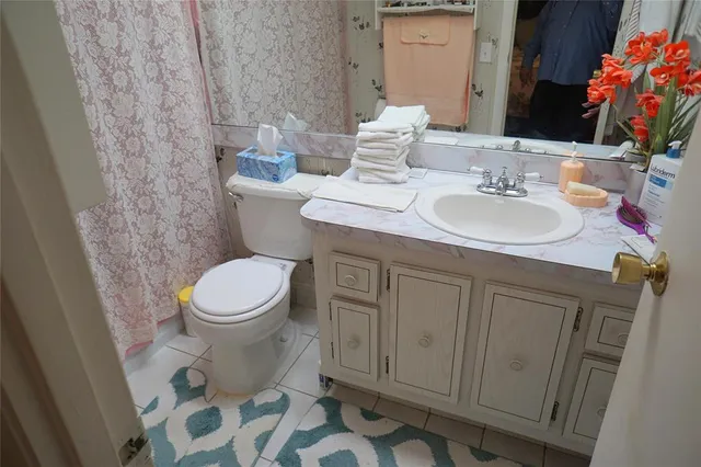 a bathroom with a sink toilet and mirror