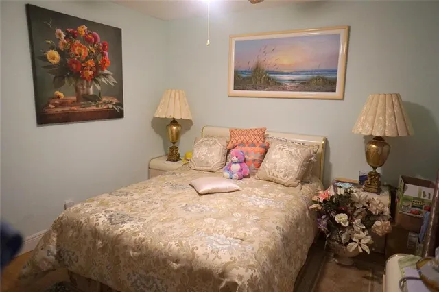 a bedroom with a bed and a painting on the wall