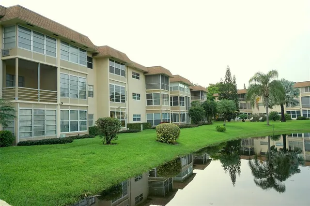 a view of a house with backyard sitting area and garden