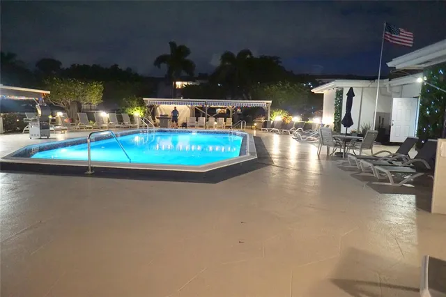 a view of a swimming pool with outdoor seating