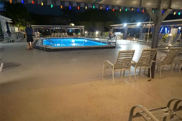 a view of swimming pool with outdoor seating