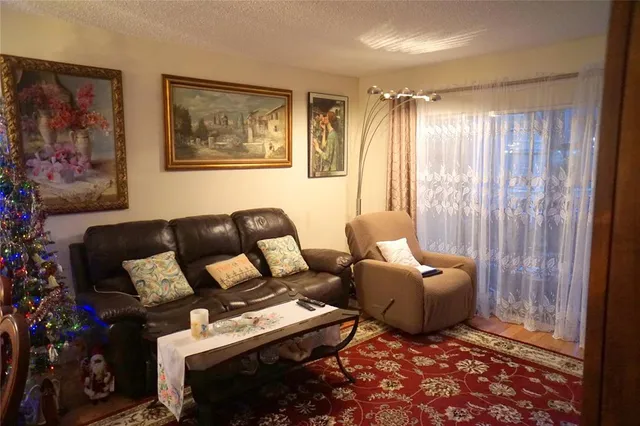 a living room with furniture and a painting on the wall