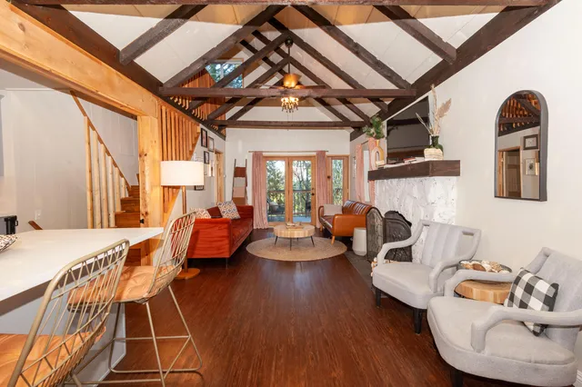 a living room with furniture and a chandelier