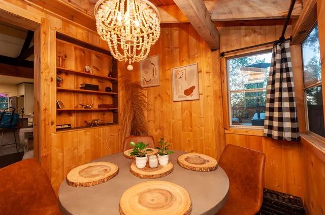 a dining room with furniture and wooden floor