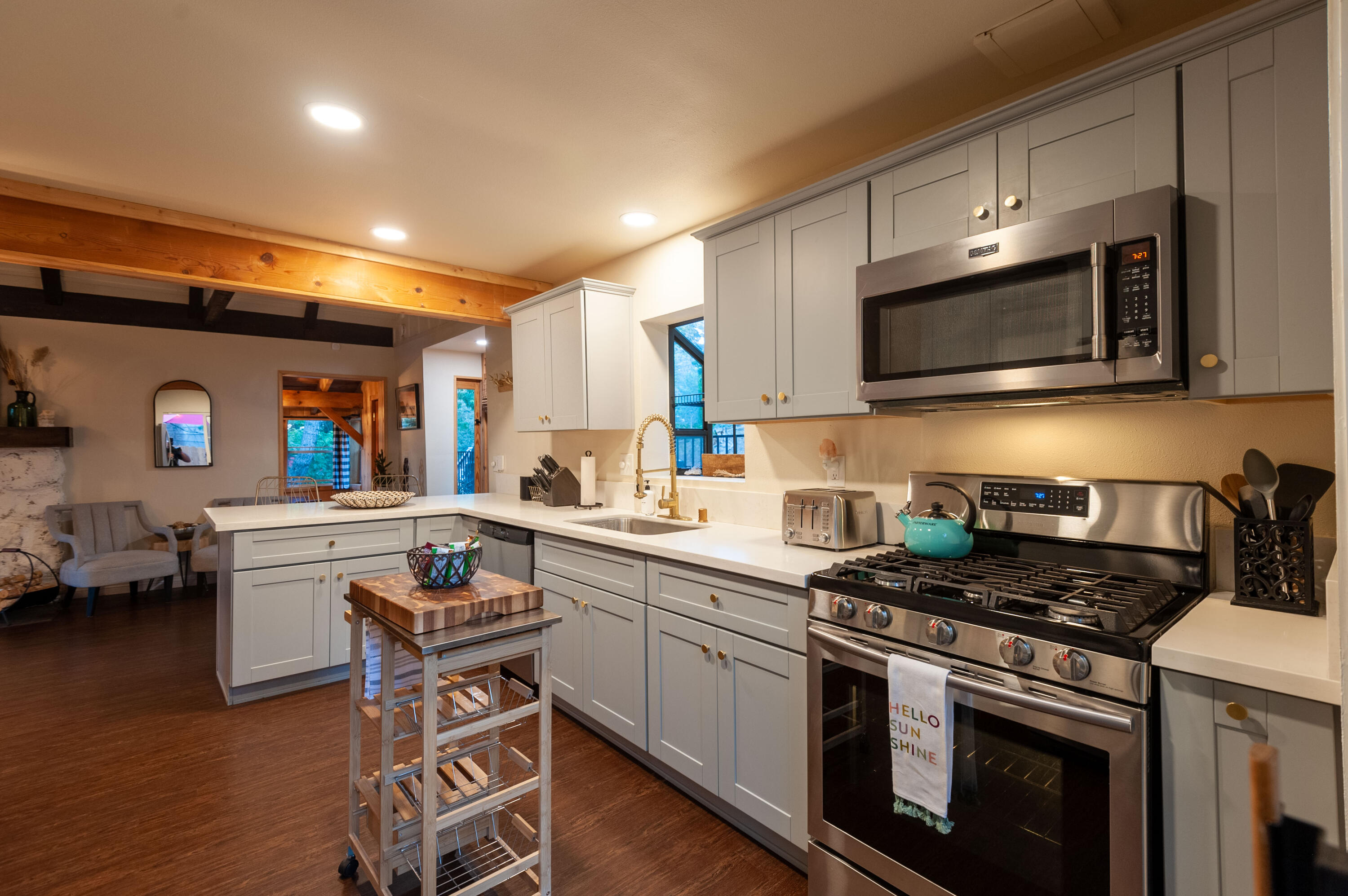 644 Cedar Lane Twin Peaks, CA 92391 - Photo 18 of 41 a kitchen with a sink cabinets and wooden floor