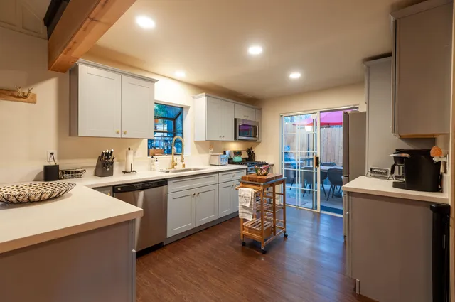 a kitchen with granite countertop a sink stove and cabinets