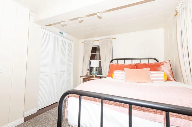 a bedroom with a bed and a large window