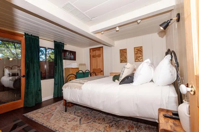 a bedroom with a large bed and a dresser