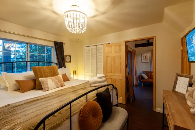 a bedroom with furniture and a chandelier