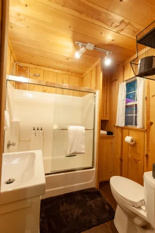 a bathroom with a toilet and a shower