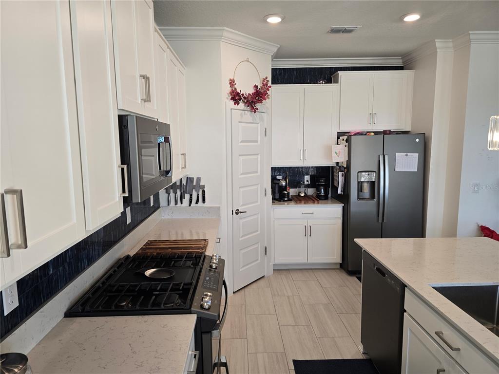8280 Rolling Tides Drive New Port Richey, FL 34655 - Photo 14 of 49 a kitchen with granite countertop a refrigerator stove top oven and sink