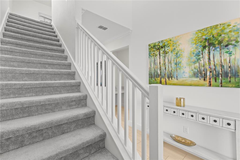 8280 Rolling Tides Drive New Port Richey, FL 34655 - Photo 18 of 49 a view of entryway with stairs and wooden floor