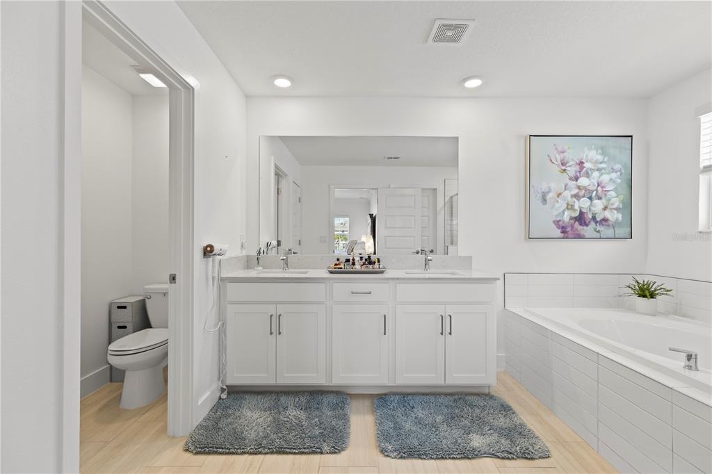 8280 Rolling Tides Drive New Port Richey, FL 34655 - Photo 21 of 49 a spacious bathroom with a double vanity sink a mirror and a bathtub