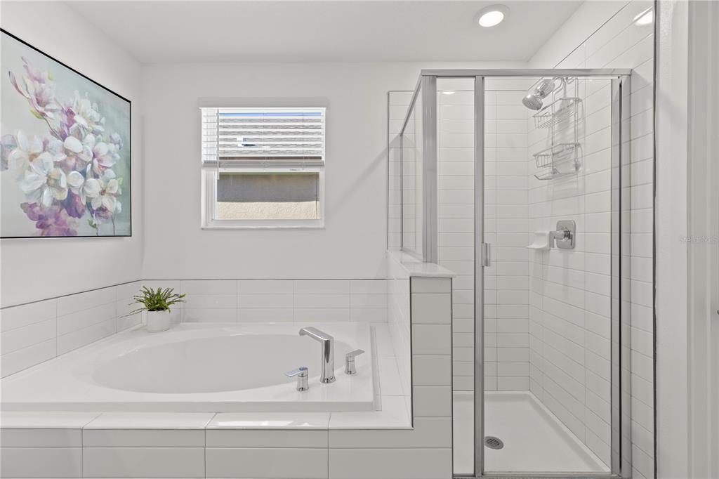 8280 Rolling Tides Drive New Port Richey, FL 34655 - Photo 22 of 49 a bathroom with a bathtub and shower