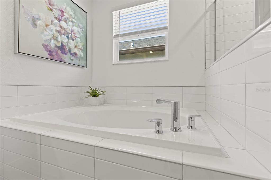 8280 Rolling Tides Drive New Port Richey, FL 34655 - Photo 23 of 49 a bathroom with a bathtub and a shower