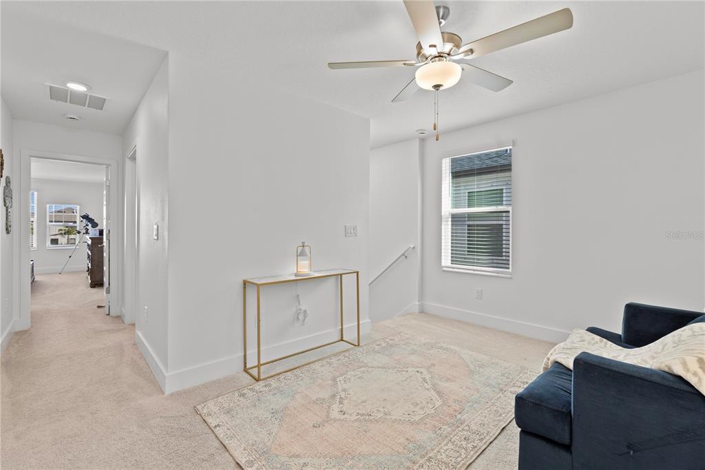 8280 Rolling Tides Drive New Port Richey, FL 34655 - Photo 25 of 49 a living room with furniture and a ceiling fan