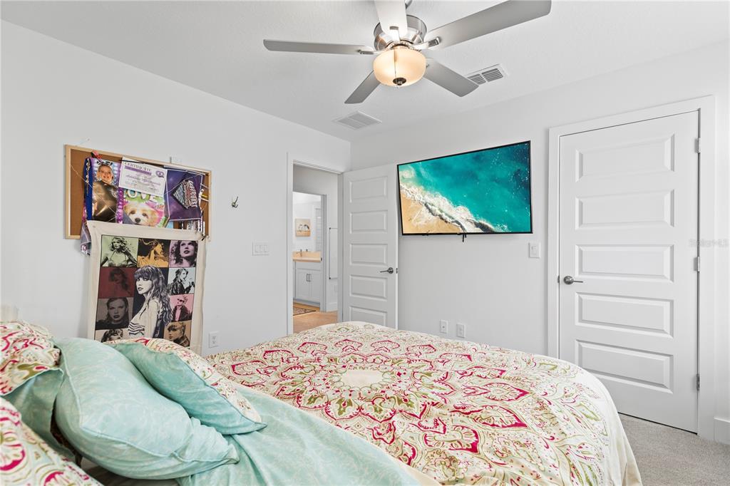 8280 Rolling Tides Drive New Port Richey, FL 34655 - Photo 32 of 49 a bedroom with a bed and a chandelier