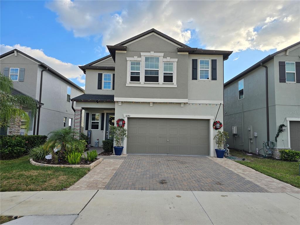 8280 Rolling Tides Drive New Port Richey, FL 34655 - Photo 48 of 49 a front view of a house with a yard and garage