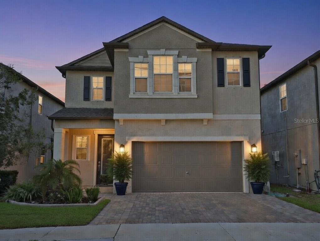 8280 Rolling Tides Drive New Port Richey, FL 34655 - Photo 49 of 49 a front view of a house with a yard and garage