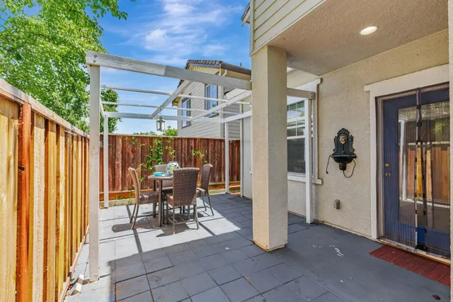 a view of a patio with table and chairs and potted plants