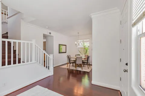a hallway with wooden floor and furniture