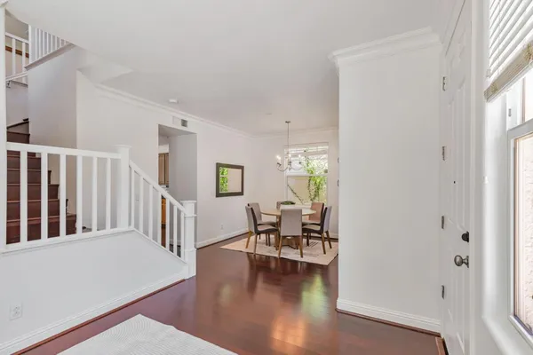 a hallway with wooden floor and furniture