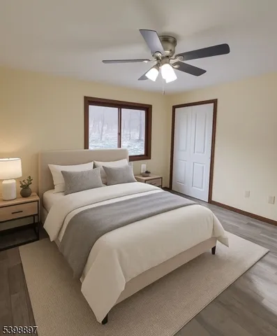 a bedroom with a large bed and a ceiling fan