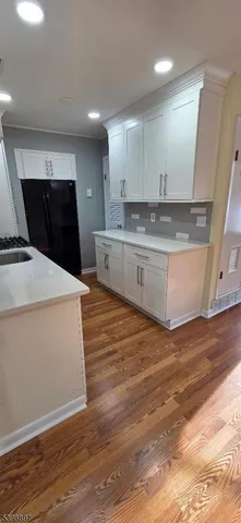 a view of kitchen with granite countertop sink and stove