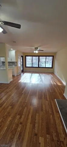 a view of a room with wooden floor