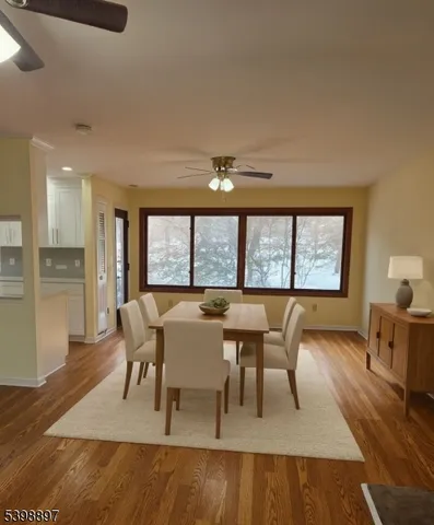 a dining room with furniture and wooden floor
