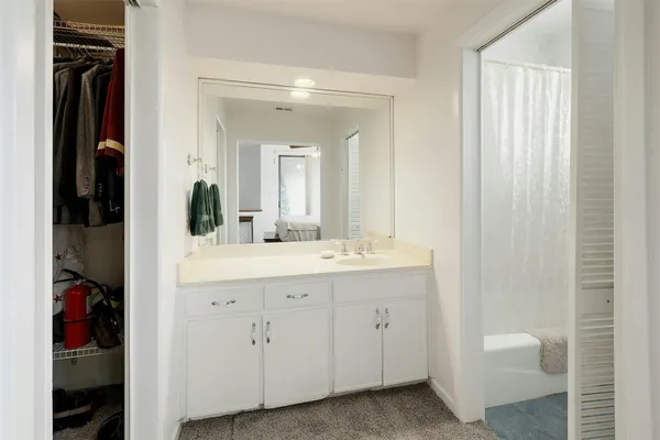 a bathroom with a double vanity sink and a mirror