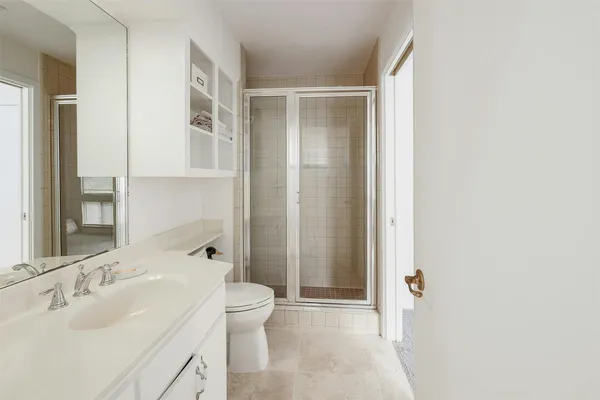 a bathroom with a sink toilet and shower