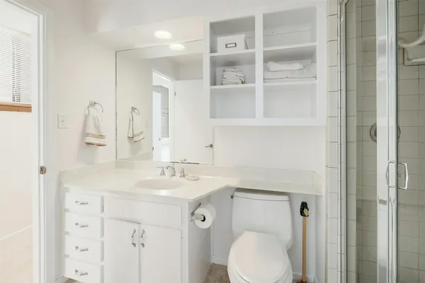 a bathroom with a sink toilet and shower