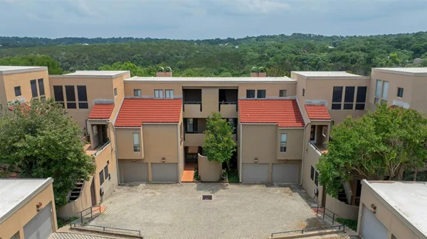 a aerial view of a house with a yard and a garage