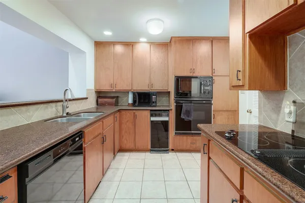 a kitchen with a sink stove and refrigerator