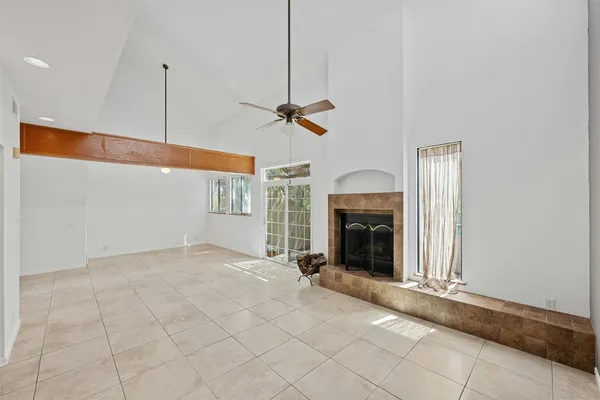 a view of an empty room with a fireplace