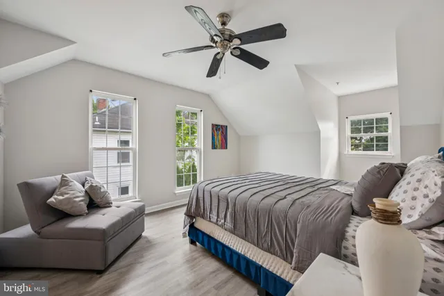 a bedroom with a bed couch and window